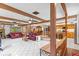 Open living room featuring tile flooring, a brick fireplace, and an open floor plan at 651 Percheron Cir, Nokomis, FL 34275