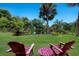 Tranquil pond with comfortable seating offering a peaceful retreat, surrounded by lush landscaping at 651 Percheron Cir, Nokomis, FL 34275