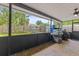 Covered porch with an outdoor kitchen, grill, and outdoor space at 651 Percheron Cir, Nokomis, FL 34275