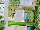 Aerial view of a home with a screened pool and mature landscaping at 705 Cadiz Rd, Venice, FL 34285