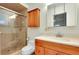 Bright bathroom with a glass door shower, and vanity with storage at 705 Cadiz Rd, Venice, FL 34285