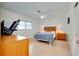 Bedroom featuring tiled flooring, a ceiling fan, and a bed with wooden headboard and matching nightstands at 705 Cadiz Rd, Venice, FL 34285