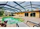 Private screened pool area with brick paver deck, lounge chairs, and outdoor seating at 705 Cadiz Rd, Venice, FL 34285