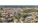 Wide aerial shot showcases a neighborhood near the coast, featuring a mix of homes and nearby amenities at 742 Golf Dr, Venice, FL 34285