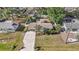 Aerial view of a single-Gathering home with a long driveway, mature landscaping, and a screened-in pool at 742 Golf Dr, Venice, FL 34285