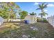 View of backyard with a shed, fence and grassy area at 742 Golf Dr, Venice, FL 34285