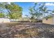 Spacious backyard with mature trees, yellow house and shed at 742 Golf Dr, Venice, FL 34285