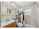 Cozy bathroom showcasing a shower with patterned curtain and a stylish mirror cabinet at 742 Golf Dr, Venice, FL 34285
