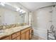 Bathroom featuring granite countertops, tub with shower, and natural lighting at 742 Golf Dr, Venice, FL 34285