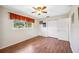 Bright bedroom features hardwood floors, a ceiling fan, and a window view of lush greenery at 742 Golf Dr, Venice, FL 34285