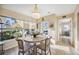 Bright dining area featuring a chandelier and views of the outdoor patio at 742 Golf Dr, Venice, FL 34285