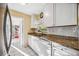 Bright kitchen with white cabinets, granite countertops and stainless steel appliances at 742 Golf Dr, Venice, FL 34285