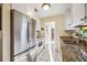 Kitchen featuring stainless steel appliances, white cabinets, and granite countertops at 742 Golf Dr, Venice, FL 34285