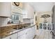 Bright kitchen with stainless steel appliances, granite countertops, and ample storage at 742 Golf Dr, Venice, FL 34285
