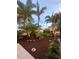 Tropical landscaping with colorful plants and mulch, and landscape lighting at 742 Golf Dr, Venice, FL 34285