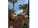 Landscaping with lush tropical plants and palm trees creating a private backyard at 742 Golf Dr, Venice, FL 34285