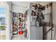 Laundry room with stacked washer and dryer and ample storage shelving at 742 Golf Dr, Venice, FL 34285