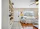 Cozy living room with wood-look flooring, white furniture, built-in shelving, and bright natural light at 742 Golf Dr, Venice, FL 34285