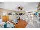 Bright living room featuring wood floors, white furniture, stylish decor, and open access to the kitchen and dining area at 742 Golf Dr, Venice, FL 34285