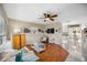 Bright living room featuring wood floors, white furniture, stylish decor, and open access to the kitchen and dining area at 742 Golf Dr, Venice, FL 34285