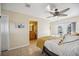Bedroom with a ceiling fan, door to the outside, and an attached bathroom at 742 Golf Dr, Venice, FL 34285
