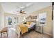 Bright bedroom with patio access, featuring a ceiling fan and inviting decor at 742 Golf Dr, Venice, FL 34285