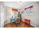 Inviting home office with a blue glass desk, wicker chair, and natural light at 742 Golf Dr, Venice, FL 34285