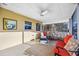 Relaxing screened patio featuring comfortable seating and a ceiling fan at 742 Golf Dr, Venice, FL 34285