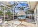 Screened patio features a shaded outdoor daybed surrounded by lush tropical landscaping at 742 Golf Dr, Venice, FL 34285