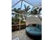 Secluded outdoor space with a shaded daybed surrounded by tropical foliage at 742 Golf Dr, Venice, FL 34285