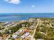 A picturesque aerial view of a charming waterfront community with beautiful blue ocean and lush green trees at 771 Stewart St, Englewood, FL 34223