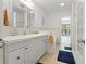 Bright bathroom featuring double vanity and a glimpse of the pool area at 771 Stewart St, Englewood, FL 34223