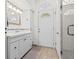 Bright bathroom with a vanity, tile floor, and a large shower with a glass door at 771 Stewart St, Englewood, FL 34223
