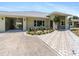 Charming single-story home featuring an attached carport, and attractive landscaping at 771 Stewart St, Englewood, FL 34223