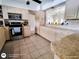 Traditional kitchen with tile floor, stainless steel range, tan granite countertops, and abundant cabinetry at 771 Stewart St, Englewood, FL 34223