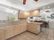 Open kitchen featuring light wood cabinets and tile flooring at 771 Stewart St, Englewood, FL 34223