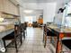 View from the kitchen into the open-concept dining and living areas with tile flooring at 771 Stewart St, Englewood, FL 34223