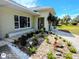 Beautifully landscaped front yard with a variety of plants, decorative stones, and a charming walkway at 771 Stewart St, Englewood, FL 34223