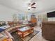 A spacious living room showcasing comfortable sofas, neutral walls, and a tiled floor at 771 Stewart St, Englewood, FL 34223