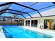 Refreshing screened pool with a spacious deck area and room for lounging at 771 Stewart St, Englewood, FL 34223