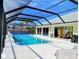 Screened-in pool with clear, refreshing water and bright outdoor space at 771 Stewart St, Englewood, FL 34223