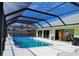 The screened pool invites relaxation with bright water and an ample deck space at 771 Stewart St, Englewood, FL 34223