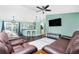 View of the living room featuring hardwood floors and a leather sofa set with ceiling fan at 7809 Grafton Rd, North Port, FL 34291