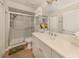 Clean bathroom featuring a glass shower, neutral colors, and a bright vanity area at 800 Gardens Edge Dr # 814, Venice, FL 34285
