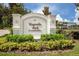 Attractive entrance sign for Magnolia Park, a condominium community with lush landscaping at 800 Gardens Edge Dr # 814, Venice, FL 34285