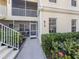 Close up of the unit entrance with table and chairs visible through the screened lanai at 800 Gardens Edge Dr # 814, Venice, FL 34285