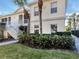Beautiful condo exterior with lush landscaping, a manicured lawn, and a sidewalk to the front door at 800 Gardens Edge Dr # 814, Venice, FL 34285