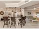 Modern open kitchen with granite counters, stainless steel appliances, dining table and seating, open to the living area at 800 Gardens Edge Dr # 814, Venice, FL 34285