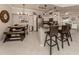 Modern open kitchen with granite counters, stainless steel appliances, dining table and seating, open to the living area at 800 Gardens Edge Dr # 814, Venice, FL 34285