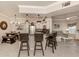Modern open kitchen with granite counters, stainless steel appliances, dining table and seating, open to the living area at 800 Gardens Edge Dr # 814, Venice, FL 34285